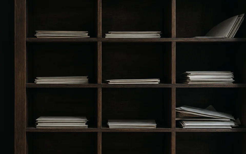 Wooden shelf with mail compartments and sorted envelopes